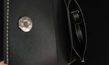 Load image into Gallery viewer, Close-up of cell phone bag with stitching detail on a dark background