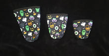 Load image into Gallery viewer, A set of three cup sleeves, in various sizes with the halloween pattern.