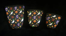Load image into Gallery viewer, A set of three cup sleeves, in various sizes with a spooky pattern.