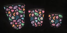 Load image into Gallery viewer, A set of three cup sleeves, in various sizes with the pastel icons pattern.