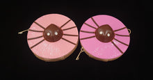 Load image into Gallery viewer, Two pink wristlet wallets with a brown center resembling a spider laying on top of a donut, featuring a detachable strap.