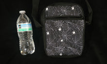 Load image into Gallery viewer, Spiderweb print messenger bag with watter bottle next to it to show size comparison.