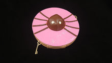 Load image into Gallery viewer, A dark pink wristlet wallet with a brown center resembling a spider laying on top of a donut, featuring a detachable strap.