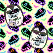 Load image into Gallery viewer, A funfetti-themed pattern of coffin-shaped cakes with ‘RIP’ frosting, and bats in a pink, mint, purple, baby blue, and orange color scheme on a yellow cream background