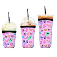 Load image into Gallery viewer, A set of three cup sleeves, in various sizes with the valloween icons pink pattern.