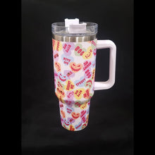 Load image into Gallery viewer, A 40oz stainless steel tumbler with a colorful Valloween-themed sweethearts pattern.