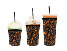 Load image into Gallery viewer, A set of three cup sleeves, in various sizes, each with the pumpkin paisley pattern.