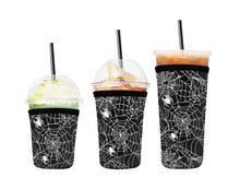 Load image into Gallery viewer, A set of three cup sleeves, in various sizes with the spiderwebs pattern.