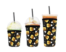 Load image into Gallery viewer, A set of three cup sleeves, in various sizes with the skelly corn pattern.