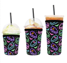 Load image into Gallery viewer, A set of three cup sleeves, in various sizes with the coffin cakes pattern.