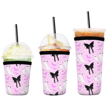 Load image into Gallery viewer, A set of three cup sleeves, in various sizes with the ghostly pattern.