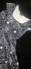 Load image into Gallery viewer, Close up of Romper dress with white spider web and spider pattern on a dark background