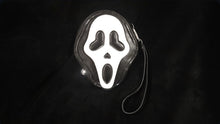 Load image into Gallery viewer, Wristlet wallet of Ghostface with heart eyes and a glow in the dark face.

