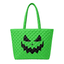Load image into Gallery viewer, A bright green quilted tote bag with a black jack-o'-lantern face design on the front.
