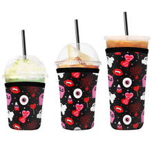 Load image into Gallery viewer, A set of three cup sleeves, in various sizes with the haunt me pattern.
