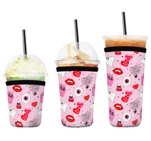 Load image into Gallery viewer, A set of three cup sleeves, in various sizes with the haunt me pink pattern.
