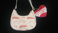 Load image into Gallery viewer, A cream-colored shoulder bag with One Wish Willow illustrations and text, featuring a matching red and white heart-shaped keychain with 'ONE WISH WILLOW' printed on it.

