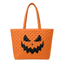 Load image into Gallery viewer, An orange quilted tote bag with a black jack-o'-lantern face design on the front.

