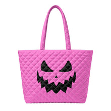 Load image into Gallery viewer, A pink quilted tote bag with a black jack-o'-lantern face graphic on the front.
