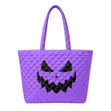 Load image into Gallery viewer, A purple quilted tote bag with a black jack-o'-lantern face design on the front.

