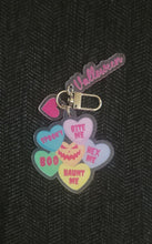 Load image into Gallery viewer, Colorful Valloween-themed keychain featuring candy heart shapes with spooky texts, such as 'Haunt Me' and 'Hex Me'
