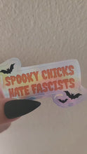 Load and play video in Gallery viewer, Video of a holographic sticker with 'Spooky Chicks Hate Fascists' text
